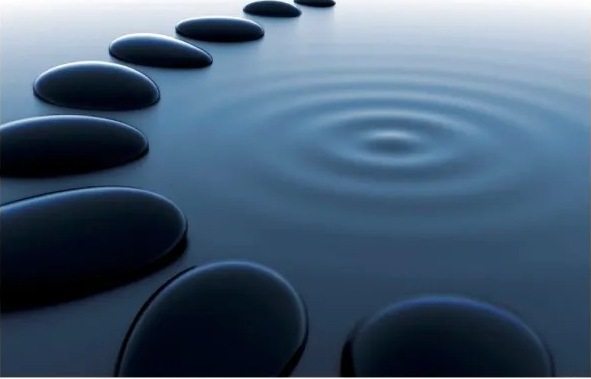 Stepping stones across calm blue water
